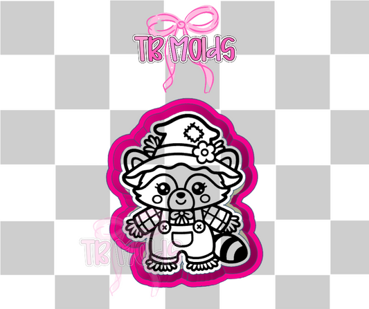 Raccoon scarecrow